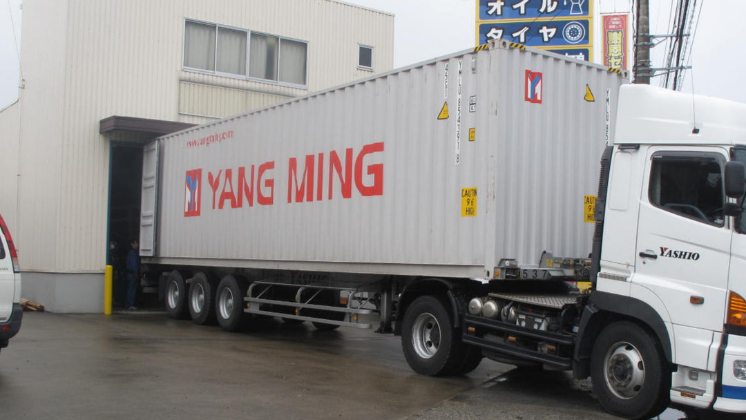 ペルシャ絨毯を積載した40フィートコンテナを倉庫に接車して荷下ろししている風景
