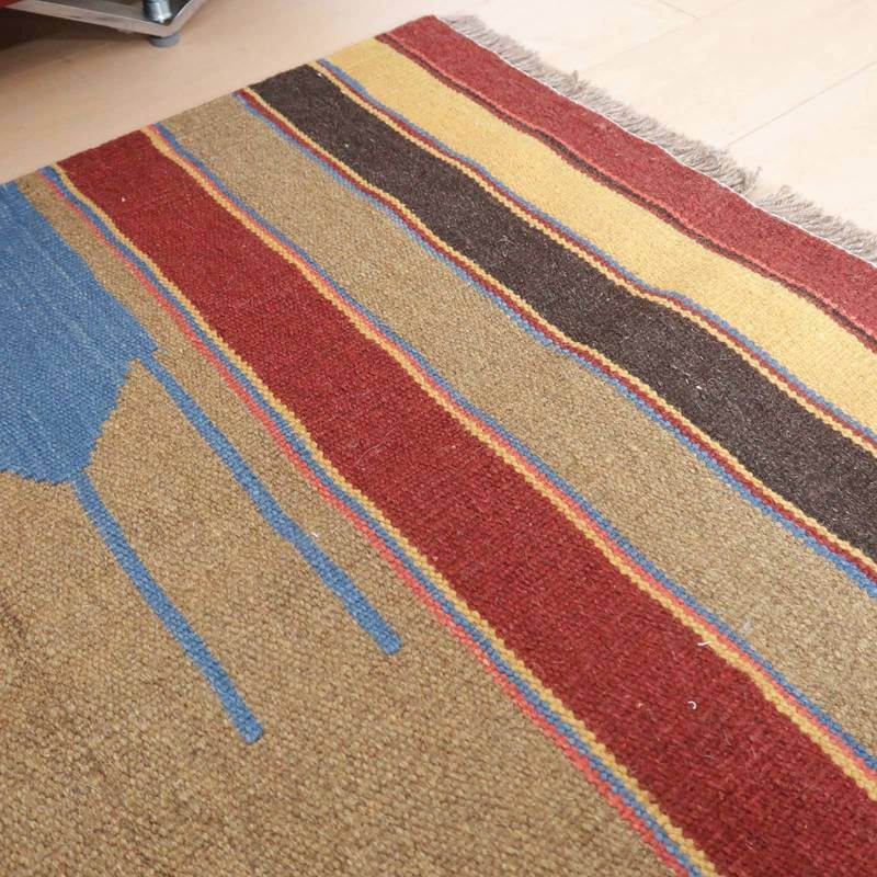 色鮮やかなストライプ模様が特徴の手織りウールラグが、ペルシャ絨毯専門店の通販で温かみを添えている。