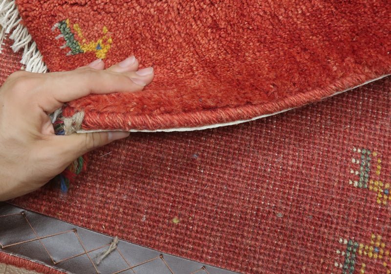 Rug — edge lifted to show the pile and thickness
