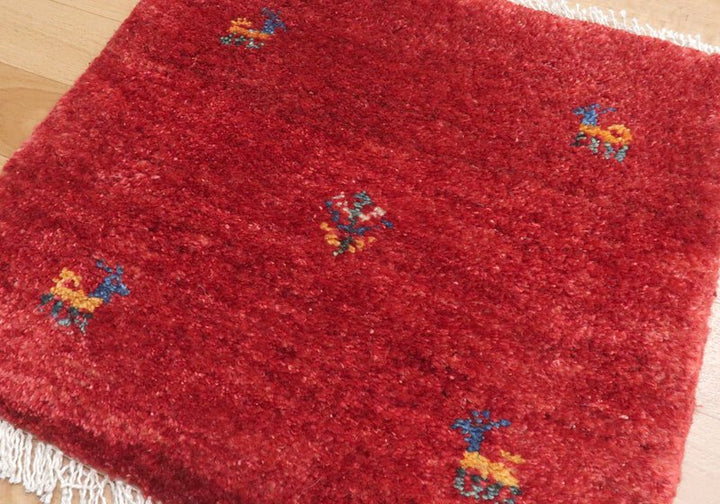 Rug in red tones — shown on the floor