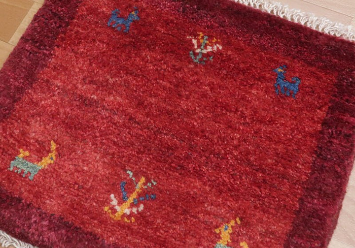Rug in red tones — shown on the floor