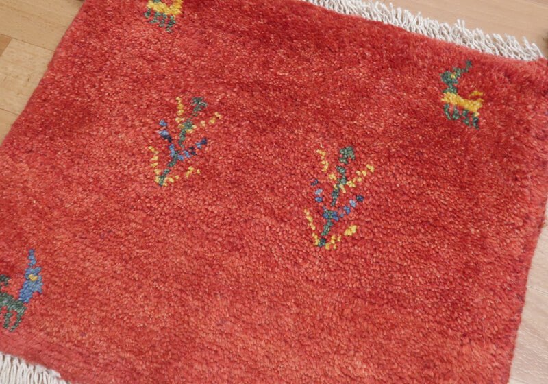 Rug in red tones — shown on the floor