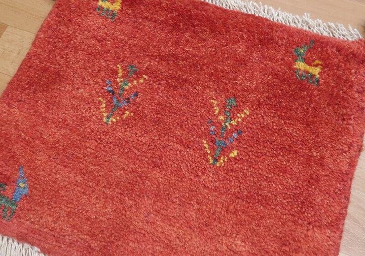 Rug in red tones — shown on the floor