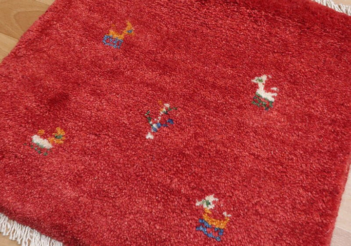 Rug with animal motifs in red