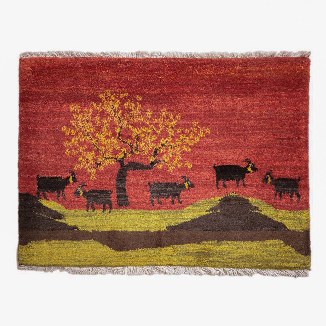 手織りのウール製ギャッベラグが、美しい赤の背景に木と動物のデザインで、ペルシャ絨毯専門店の通販で見つかる。