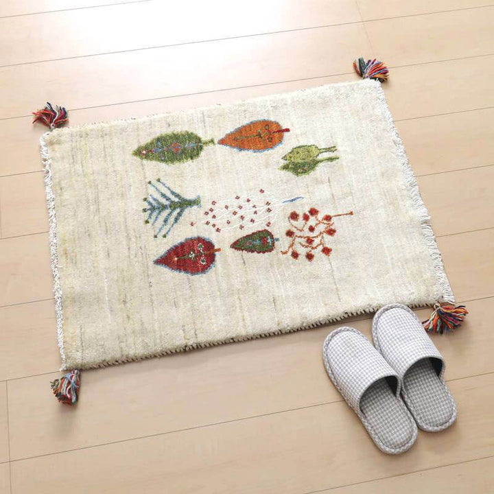 ウール素材の手織りギャッベラグがナチュラルな色合いで床に敷かれ、ペルシャ絨毯のような伝統的な模様が温かみを感じさせる一枚です。