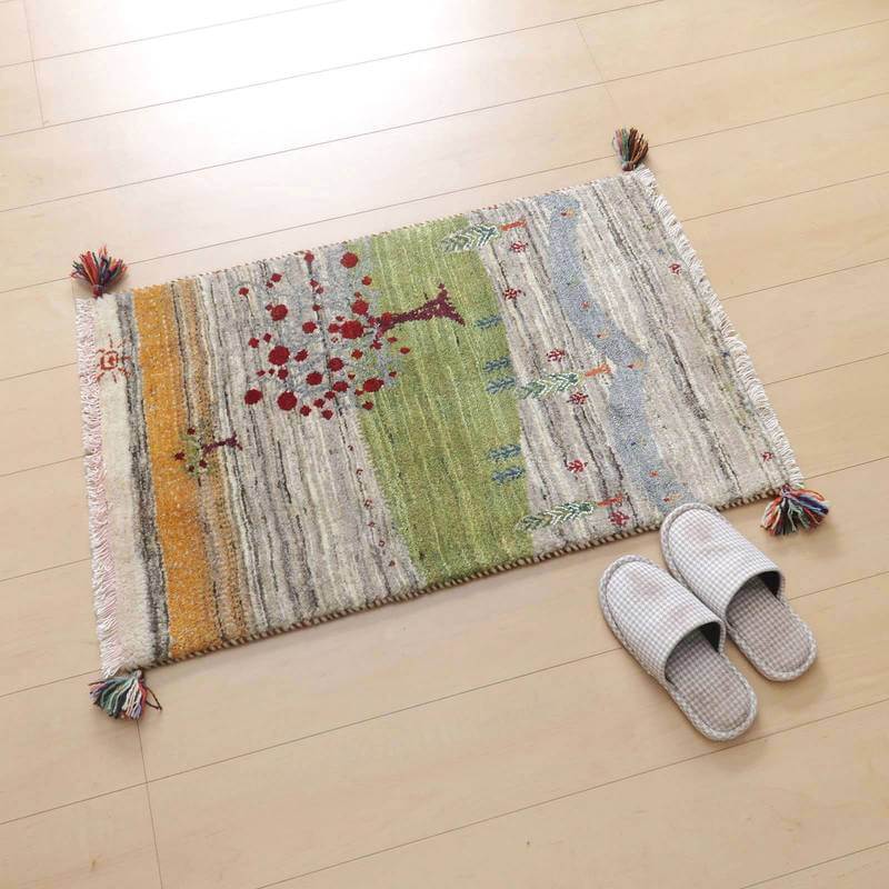 手織りのウールで作られたペルシャ絨毯専門店のギャッベラグが、温かみのある模様とともに床に敷かれている。