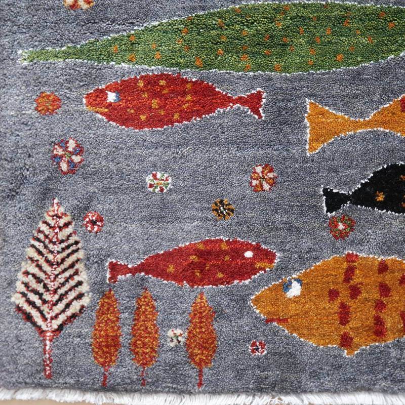 多彩な魚や植物が浮かぶデザインが魅力の手織りギャッベラグは、ウール素材のぬくもりを感じさせ、専門店の通販でペルシャ絨毯の美しさが際立っている。